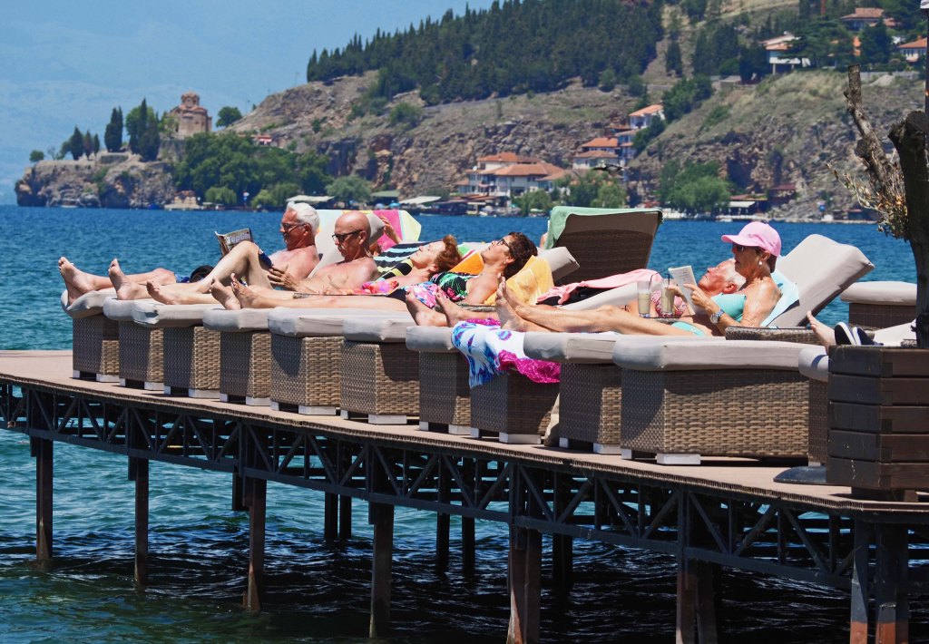Sunbathers sunbathing on the pier of Lake Ohrid